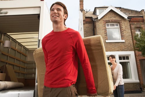 Packed moving boxes and furniture ready for transport in Westwimbledon