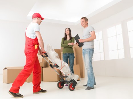 Careful unloading of boxes and furniture from a van in West Wimbledon